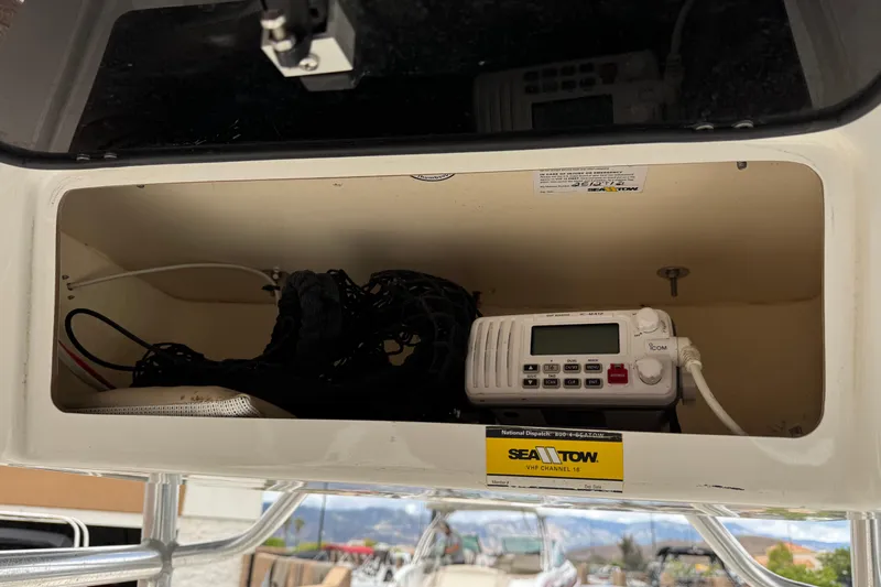 Slide: The Image of Storage compartment in a 2014 Carolina Skiff 23 Ultra Elite SS with radio equipment. - 18