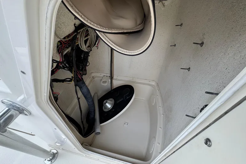 Slide: The Image of 2014 Carolina Skiff 23 Ultra Elite SS storage compartment with wiring and equipment. - 20