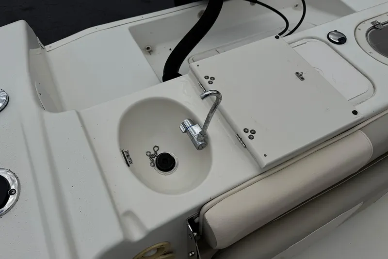 Slide: The Image of 2014 Carolina Skiff 23 Ultra Elite SS boat sink and seating area detail. - 24