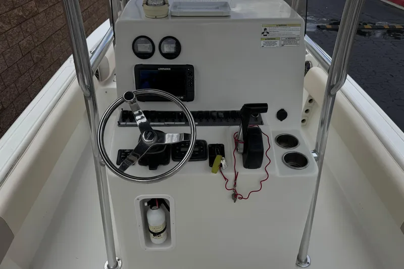 Slide: The Image of 2014 Carolina Skiff 23 Ultra Elite SS boat console with steering wheel and navigation controls. - 28
