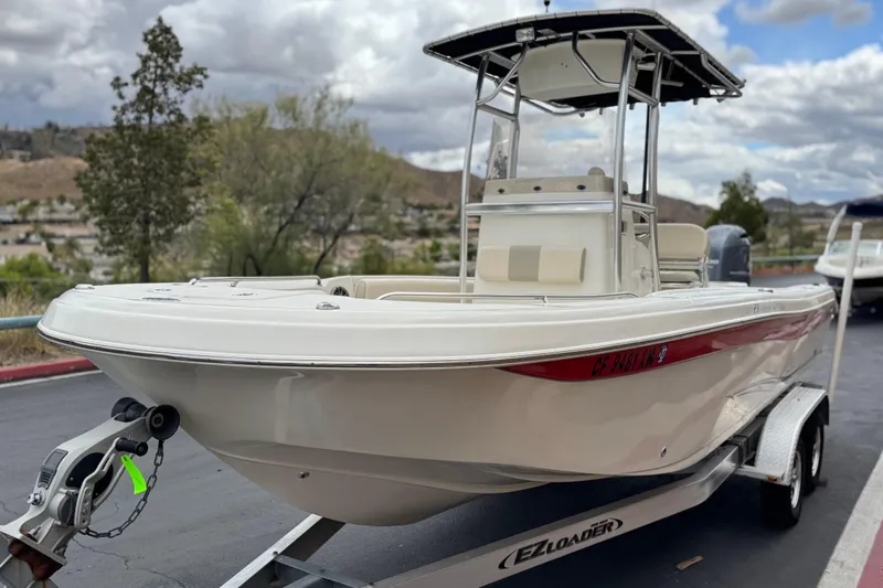 Slide: The Image of 2014 Carolina Skiff 23 Ultra Elite SS boat on trailer, parked outdoors. - 3