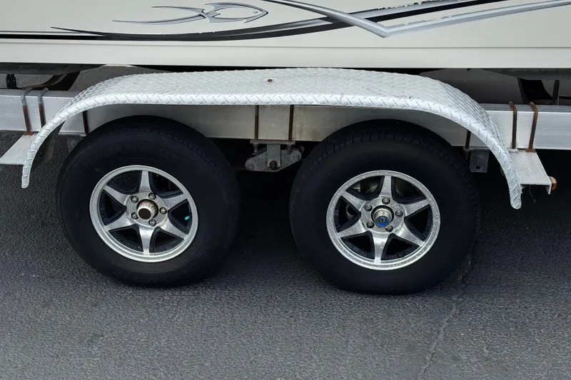 Slide: The Image of Trailer wheels of a 2014 Carolina Skiff 23 Ultra Elite SS boat. - 30