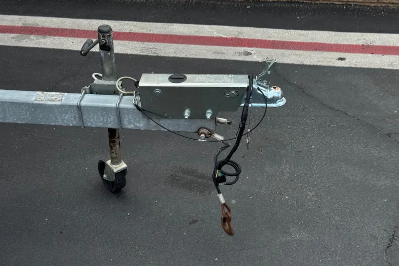 Slide: The Image of Trailer hitch for 2014 Carolina Skiff 23 Ultra Elite SS on asphalt surface. - 31