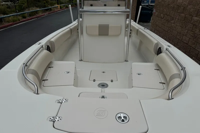 Slide: The Image of 2014 Carolina Skiff 23 Ultra Elite SS boat interior with seating and storage compartments. - 9
