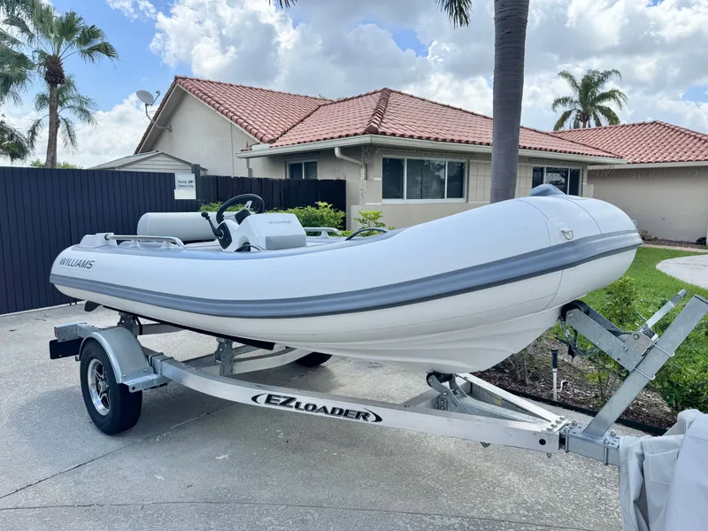 The Image of 2025 Williams Jet Tenders Sportjet 395 on trailer in front of house. - 0