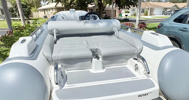 Slide: The Image of 2025 Williams Jet Tenders Sportjet 395 with gray upholstery, parked outdoors. - 11