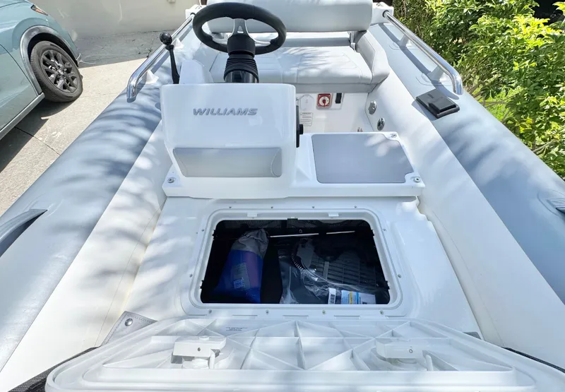 Slide: The Image of 2025 Williams Jet Tenders Sportjet 395 with open storage compartment. - 21