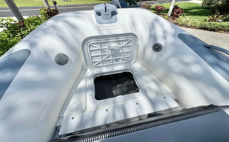 Slide: The Image of Williams Jet Tenders Sportjet 395 2025 with open storage compartment. - 23