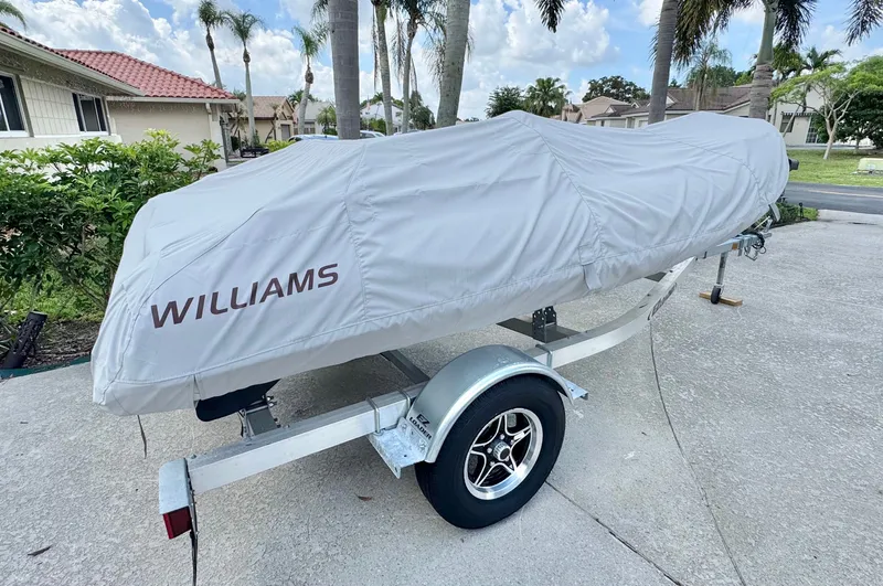 Slide: The Image of 2025 Williams Jet Tenders Sportjet 395 covered on trailer. - 3