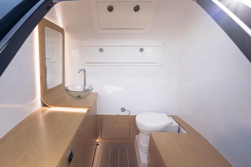 Slide: The Image of Modern boat bathroom with wooden cabinetry, glass sink, and toilet in Skipper-BSK 38NC, 2024 model. - 12