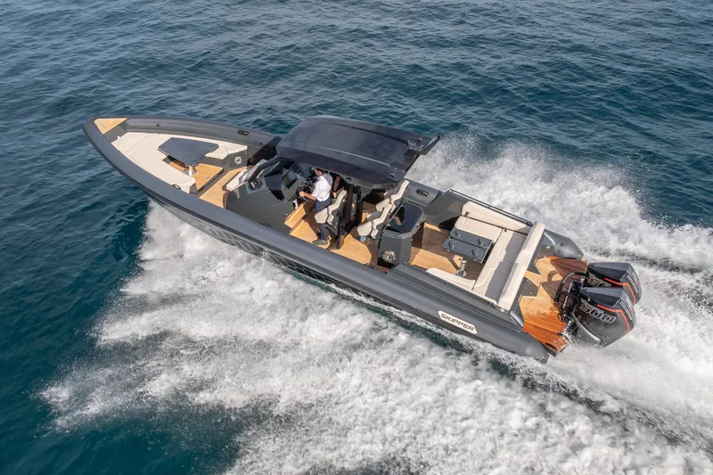 Slide: The Image of 2024 Skipper-BSK 38NC boat cruising on open water, showcasing sleek design and powerful engines. - 2