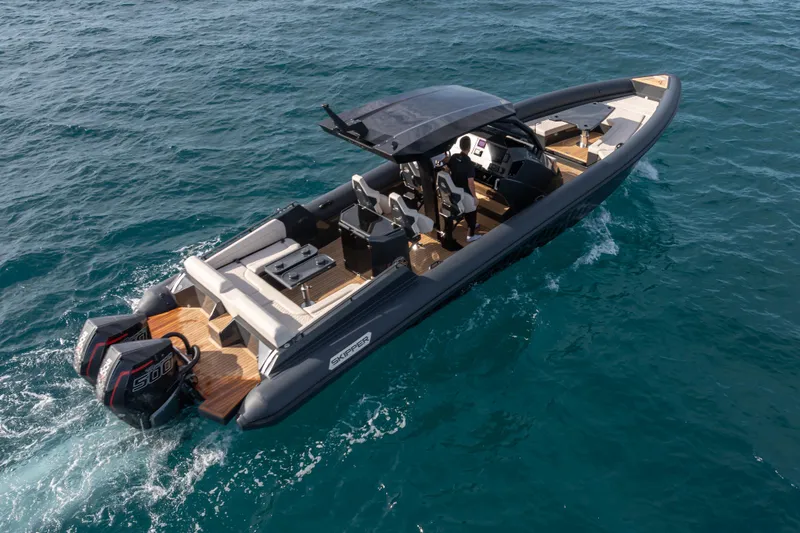 Slide: The Image of 2024 Skipper-BSK 38NC boat cruising on open water, featuring sleek design and powerful engines. - 3