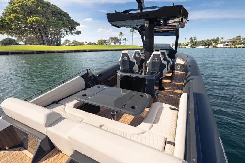 Slide: The Image of 2024 Skipper-BSK 38NC luxury boat with spacious seating and sleek design on calm waters. - 5