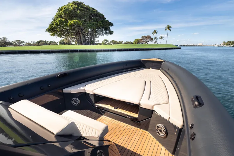 Slide: The Image of Luxurious 2024 Skipper-BSK 38NC boat with elegant seating, cruising near lush island scenery. - 9