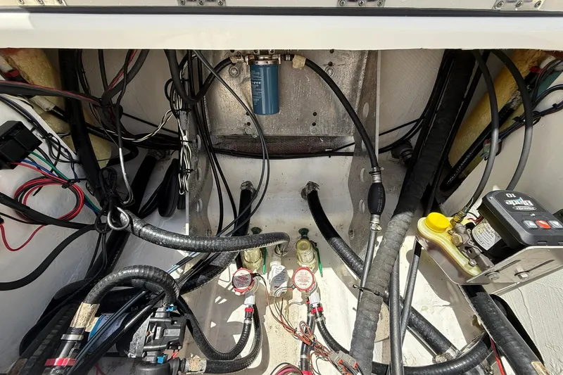 Slide: The Image of 2023 Skeeter SX2350 boat wiring and components in the engine compartment. - 10