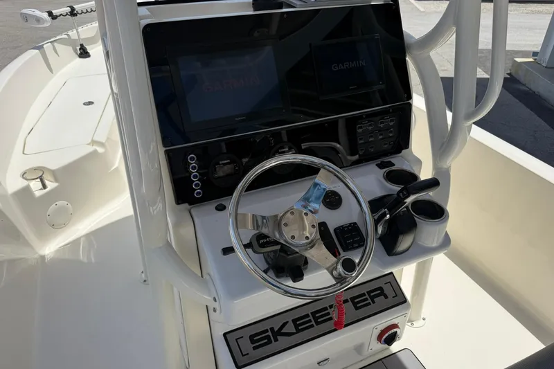 Slide: The Image of 2023 Skeeter SX2350 boat console with Garmin navigation system and steering wheel. - 13