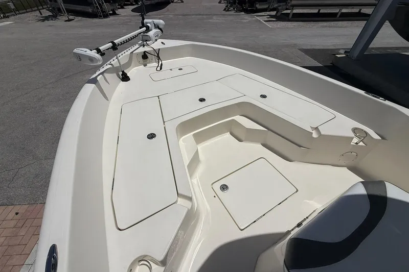 Slide: The Image of 2023 Skeeter SX2350 boat deck with storage compartments and trolling motor. - 16