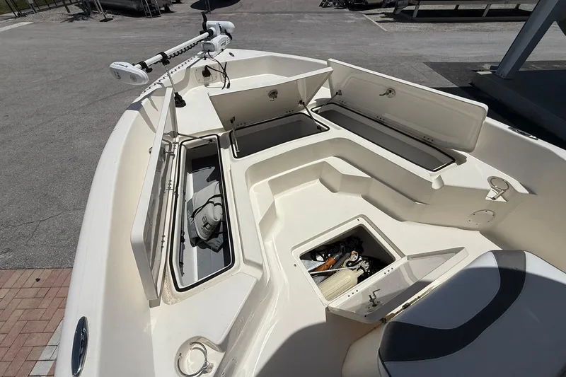 Slide: The Image of 2023 Skeeter SX2350 boat interior with open storage compartments and fishing gear. - 17