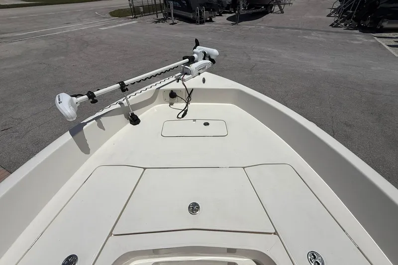 Slide: The Image of 2023 Skeeter SX2350 boat deck with trolling motor, parked on pavement. - 18