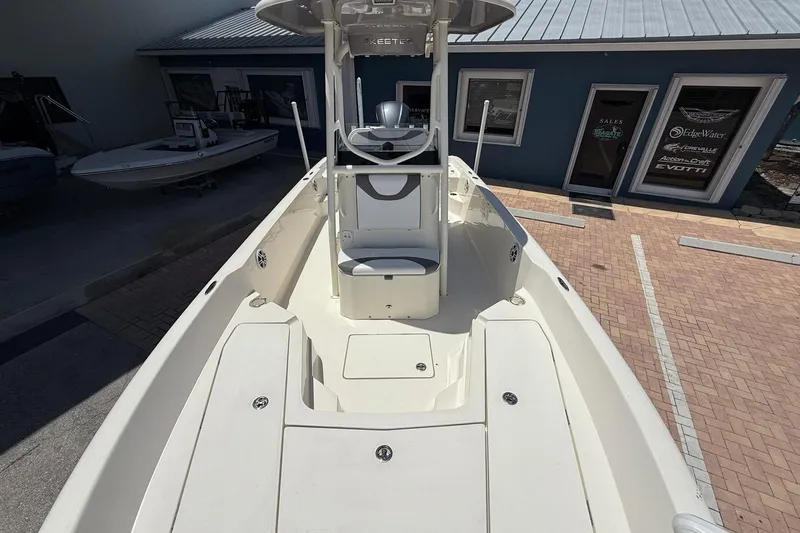 Slide: The Image of 2023 Skeeter SX2350 boat with spacious deck, parked outside a blue building. - 20