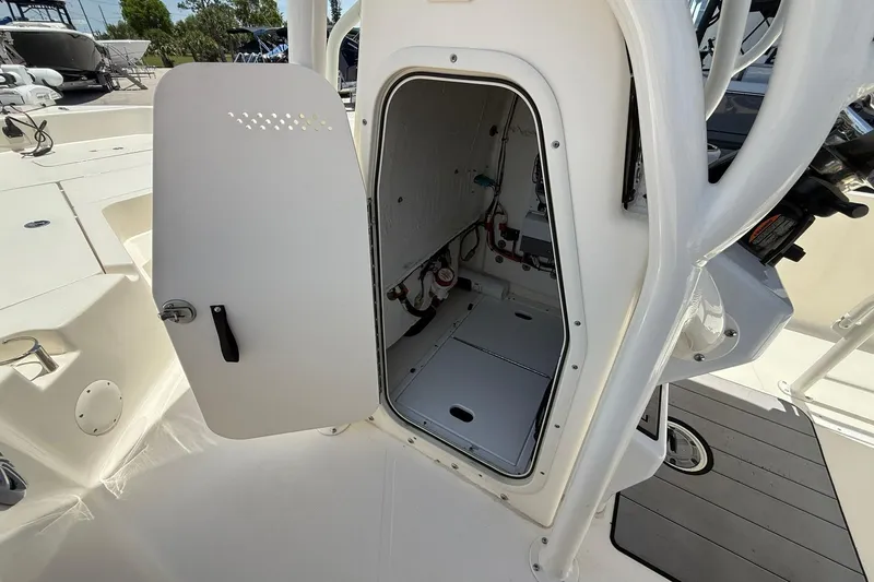 Slide: The Image of 2023 Skeeter SX2350 boat storage compartment with open door, showcasing interior details. - 23