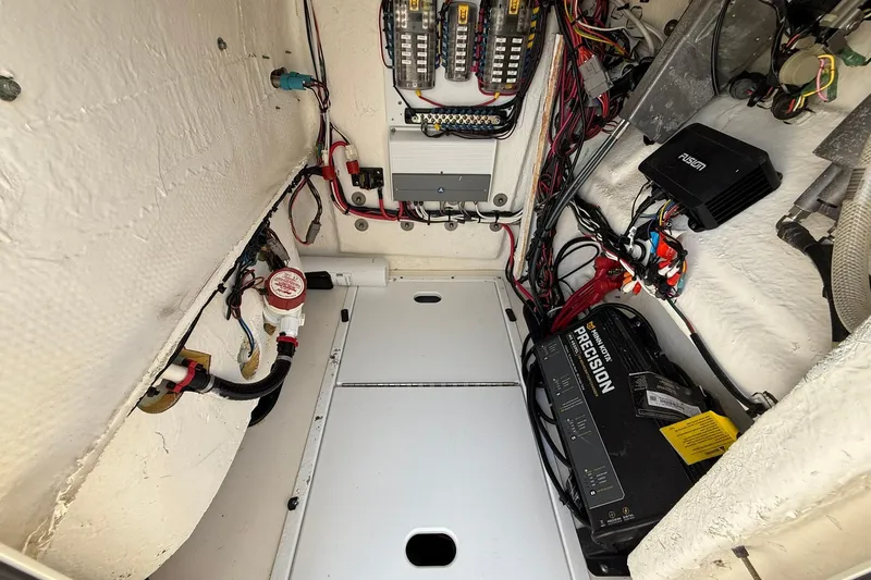Slide: The Image of Electrical compartment of 2023 Skeeter SX2350 boat with wiring and battery charger. - 24