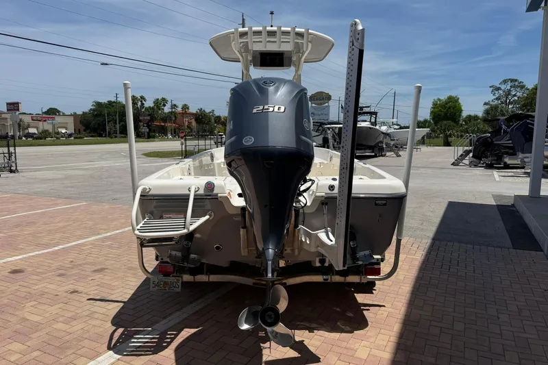 Slide: The Image of 2023 Skeeter SX2350 boat with powerful outboard motor, parked on a sunny day. - 4