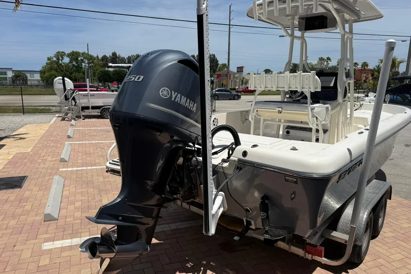 Slide: The Image of 2023 Skeeter SX2350 boat with Yamaha 250 engine, parked on a brick driveway. - 5