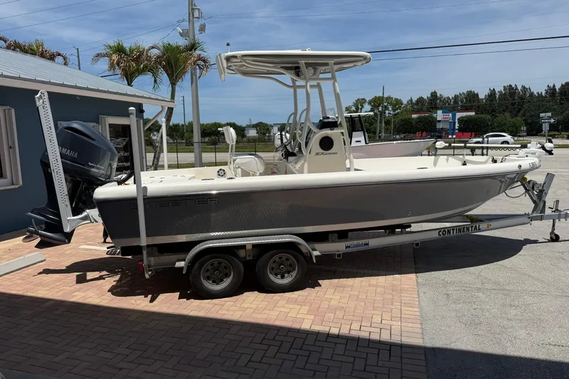 Slide: The Image of 2023 Skeeter SX2350 boat on trailer with Yamaha engine, parked outdoors. - 6