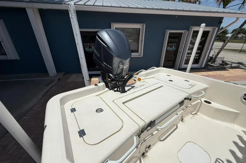 Slide: The Image of 2023 Skeeter SX2350 boat with Yamaha outboard motor, docked near a blue building. - 7