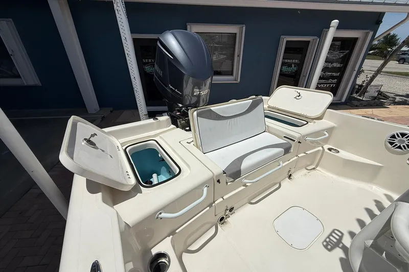 Slide: The Image of 2023 Skeeter SX2350 boat interior with Yamaha engine, open storage compartments, and seating. - 8