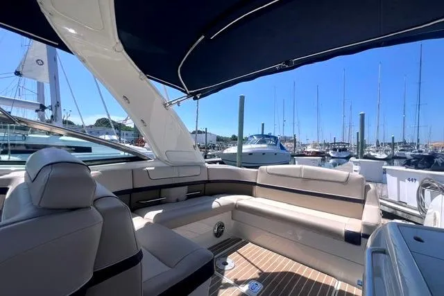 Slide: The Image of 2015 Formula 350 Sun Sport yacht interior with luxurious seating at a marina. - 18