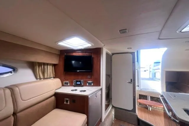 Slide: The Image of Interior of 2015 Formula 350 Sun Sport boat with seating, TV, and cabin amenities. - 13