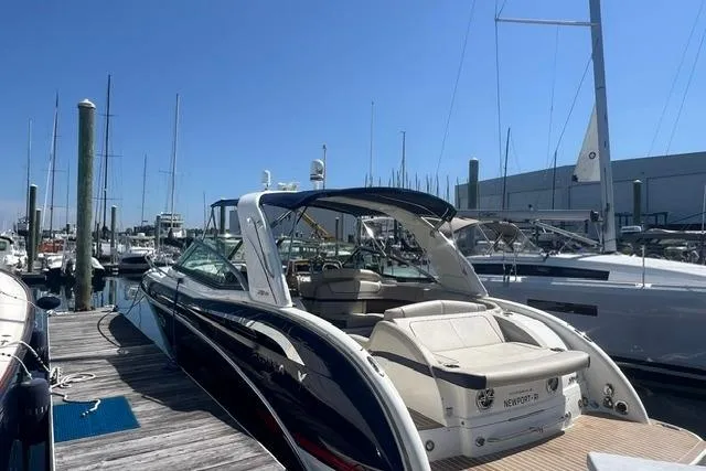Slide: The Image of 2015 Formula 350 Sun Sport boat docked at marina under clear blue sky. - 22