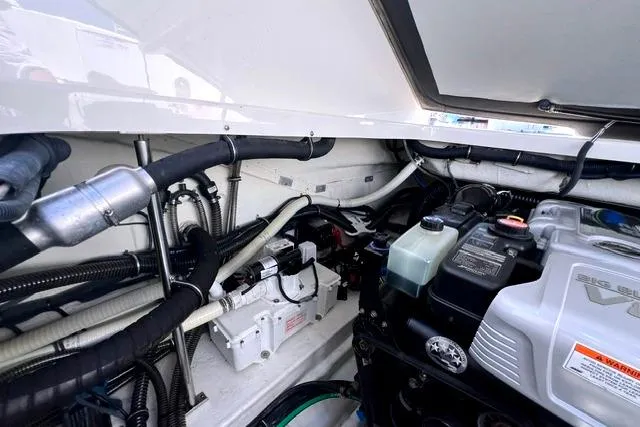 Slide: The Image of Engine compartment of a 2015 Formula 350 Sun Sport boat, showcasing mechanical components. - 25