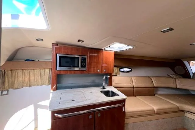 Slide: The Image of Interior of 2015 Formula 350 Sun Sport boat with kitchenette and seating area. - 17