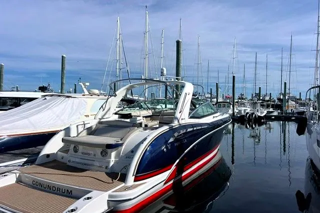 Slide: The Image of 2015 Formula 350 Sun Sport boat docked at marina with sailboats in background. - 3