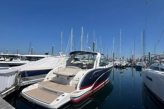 Slide: The Image of 2015 Formula 350 Sun Sport boat docked in a marina under clear blue skies. - 1