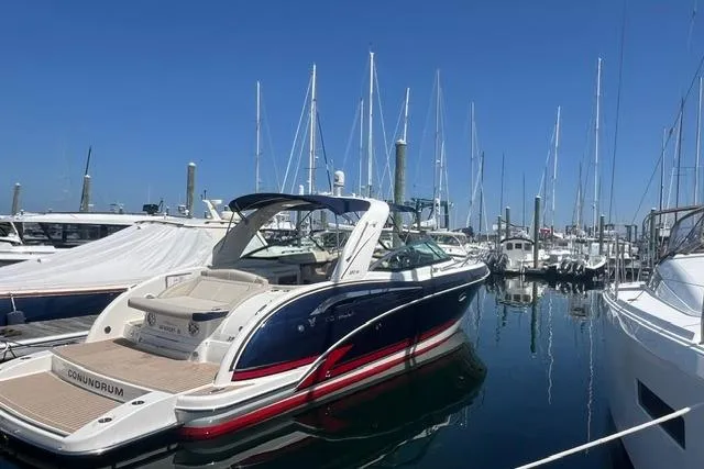 Slide: The Image of 2015 Formula 350 Sun Sport boat docked in a marina under clear blue skies. - 23