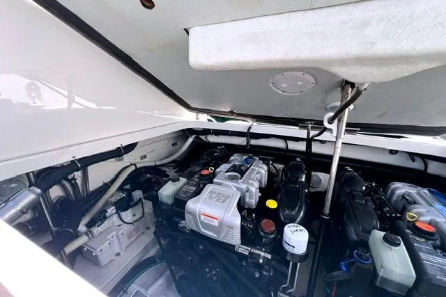 Slide: The Image of Engine compartment of a 2015 Formula 350 Sun Sport boat, showcasing V8 engine components. - 27