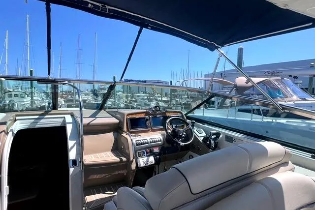 Slide: The Image of 2015 Formula 350 Sun Sport boat interior with helm, docked at marina. - 20