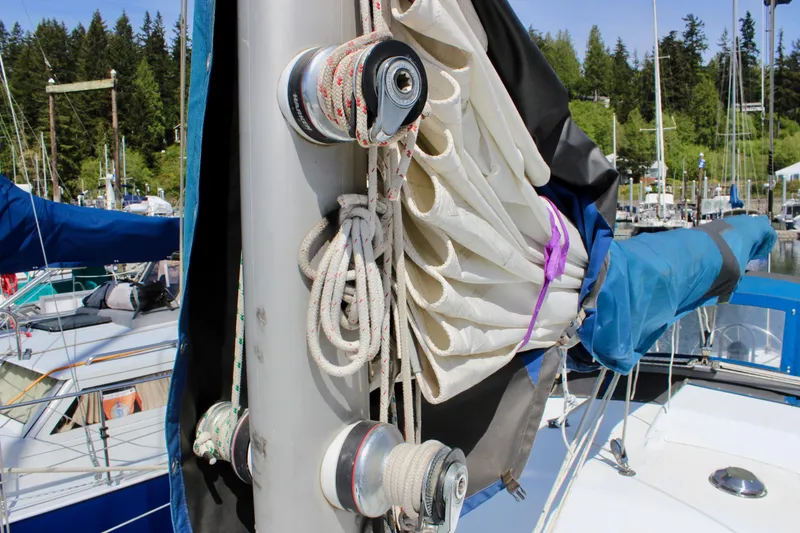 Slide: The Image of Sailboat mast with ropes and sails, Freya 39 model, 1993, docked in marina. - 11