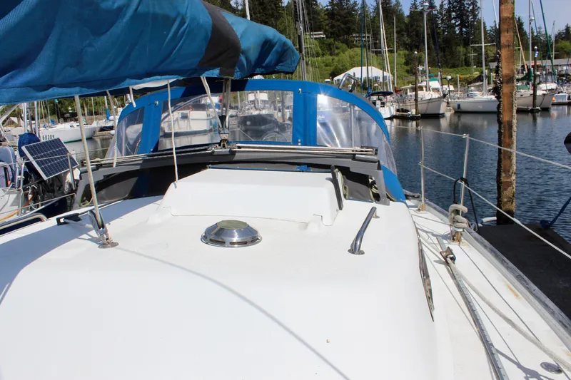 Slide: The Image of Sailboat Freya 39, 1993 model, docked at marina with blue canopy and clear skies. - 12