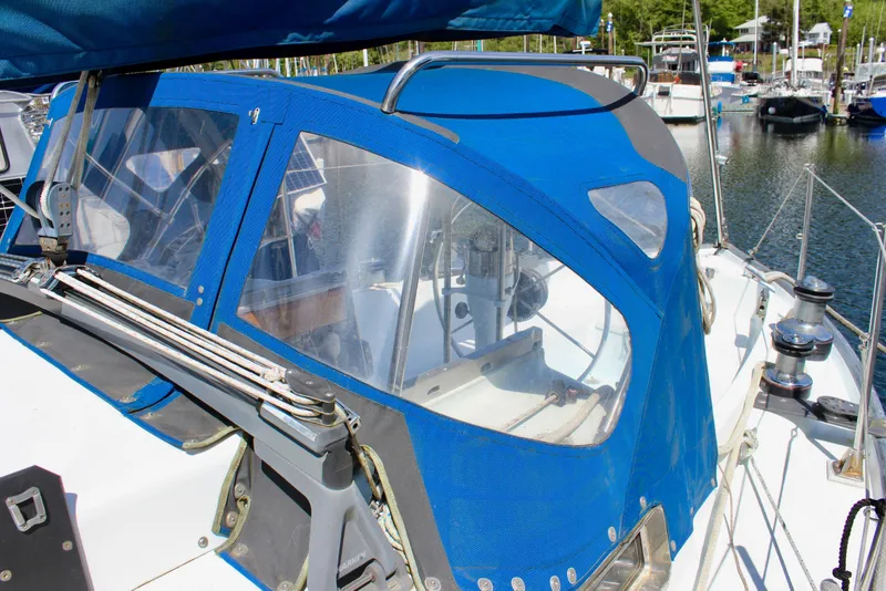 Slide: The Image of Sailboat cockpit with blue canopy, Freya 39 model, 1993, docked in marina. - 13