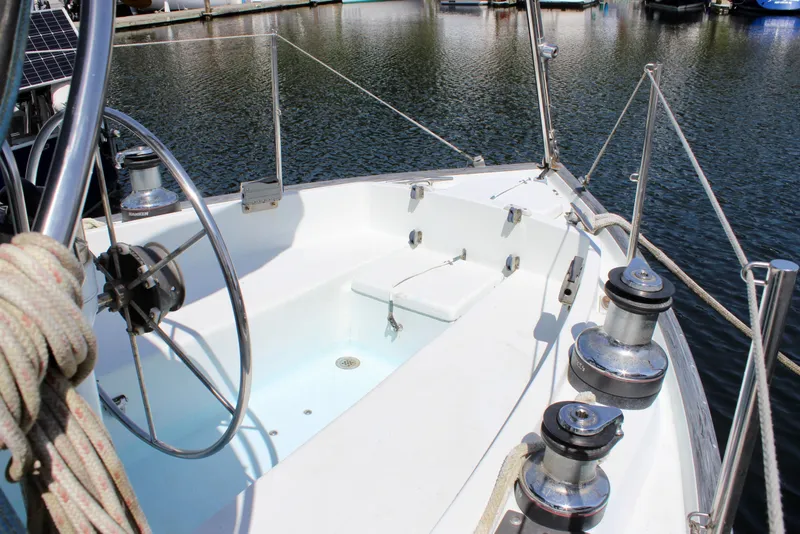 Slide: The Image of Cockpit of 1993 Freya 39 sailboat with steering wheel and winches, docked in marina. - 14