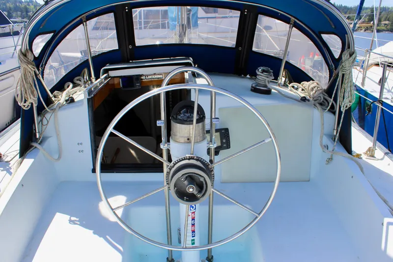 Slide: The Image of Cockpit of 1993 Freya 39 sailboat with steering wheel and nautical equipment. - 16
