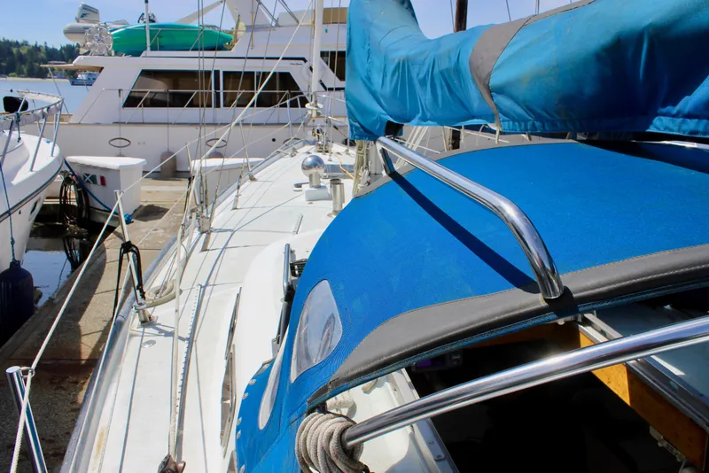 Slide: The Image of Sailboat Freya 39, 1993 model, docked with blue canopy and polished rails. - 2