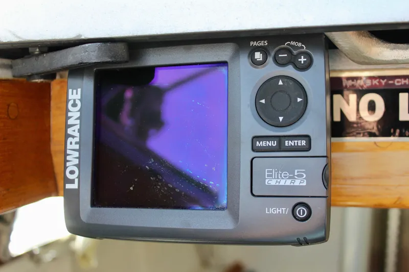 Slide: The Image of Lowrance Elite-5 CHIRP fishfinder on 1993 Freya 39 boat, mounted under a wooden panel. - 22