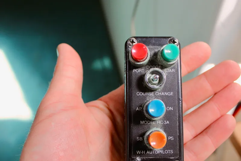 Slide: The Image of Hand holding vintage Freya 39 autopilot control panel with colorful buttons, model HC-3A, from 1993. - 26