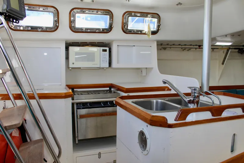 Slide: The Image of Interior of 1993 Freya 39 sailboat kitchen with sink, stove, and microwave. - 28